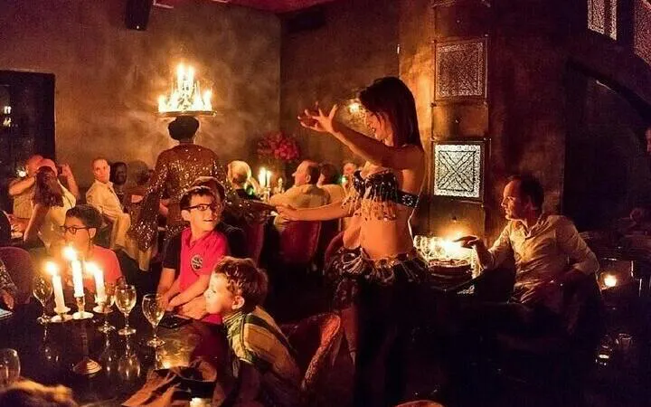 Cabaret performer entertains guests during dinner at a Hurghada night show.