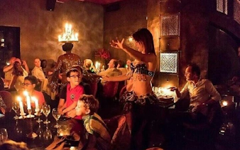 Cabaret performer entertains guests during dinner at a Hurghada night show.