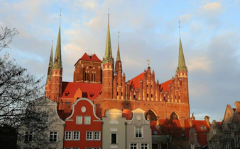 Gothic-style St. Mary's Church with spires in Gdansk Old Town during a self-guided audio walking tour.
