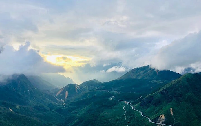 Sa Pa mountain landscape with winding road to O Quy Ho Pass at sunrise.