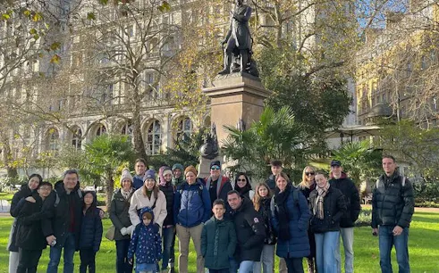Group of tourists in front of a statue during the Westminster Royal Changing of the Guard tour.