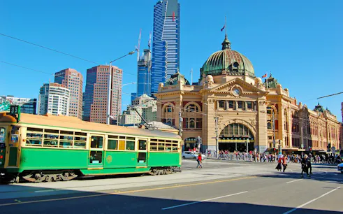 Flinders Street Station with a green tram in Melbourne, part of the Laneways and Arcades walking tour.