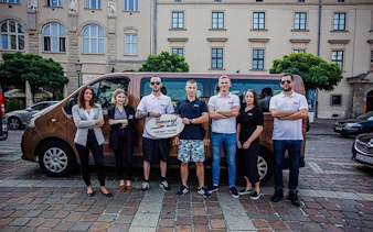 Group of people standing in front of a tour van in Krakow for an off-road quad bike tour.