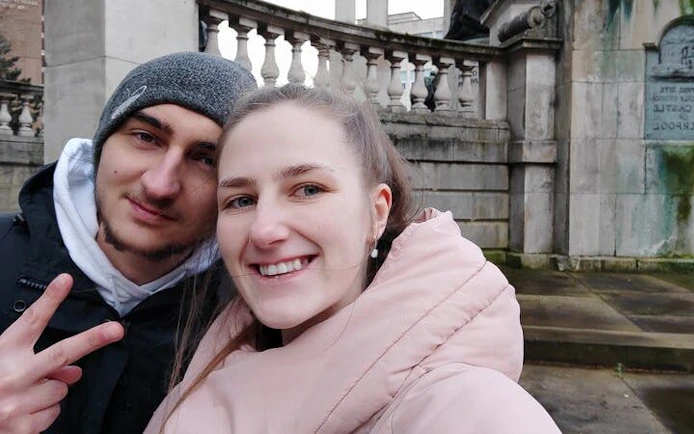 Couple exploring haunted site in Liverpool during self-guided city game.