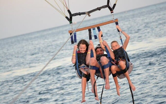 Parasailing over the Red Sea during a private speedboat tour in Sharm El Sheikh.