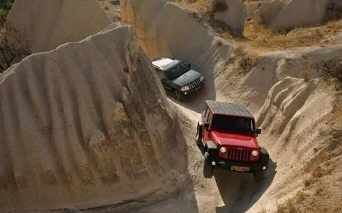 Jeep navigating rocky terrain in Cappadocia during a safari tour.