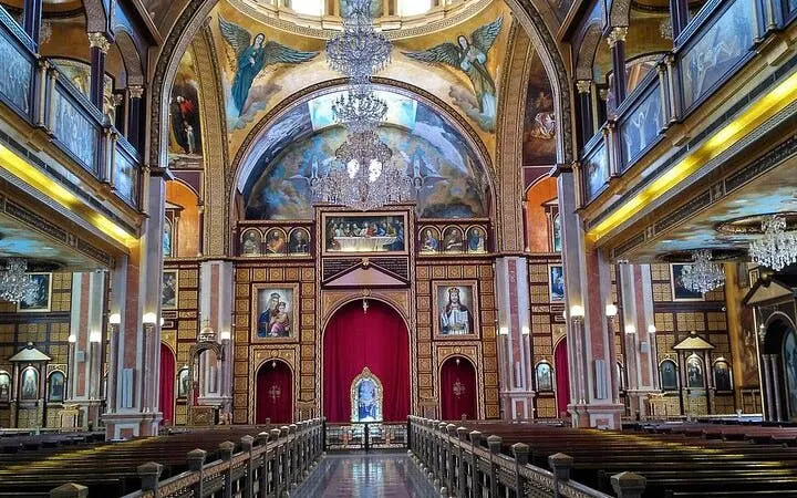 Interior of a richly decorated church with chandeliers and religious icons, Sharm El Sheikh tour.