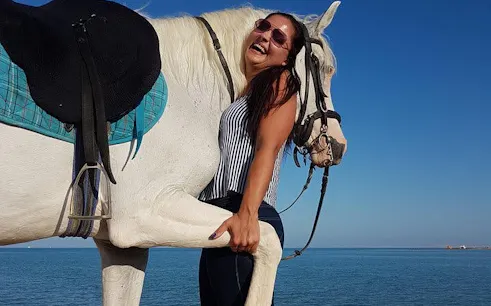 Horseback rider smiling by the Red Sea during Hurghada Desert tour.