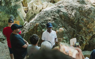 Tour guide explaining rock formations to visitors in Santo Domingo, part of a day tour from Punta Cana.
