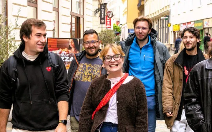 Group of tourists walking on a street in Bratislava during a Slovak food tour.