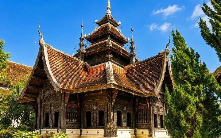 Wat Suan Dok temple with intricate wooden architecture in Chiang Mai, part of guided tour.