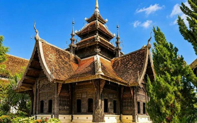 Wat Suan Dok temple with intricate wooden architecture in Chiang Mai, part of guided tour.