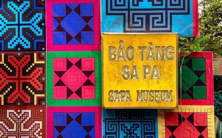 Sapa Museum sign with colorful traditional patterns in Sapa, Vietnam.