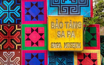 Sapa Museum sign with colorful traditional patterns in Sapa, Vietnam.