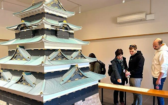 Visitors examining a model of Tokyo Castle during the Imperial Palace guided walking tour.