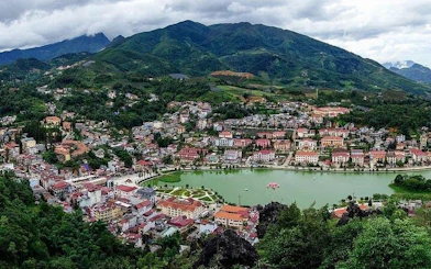 Sapa town with surrounding mountains and lake, view from trail on 21km guided running tour.