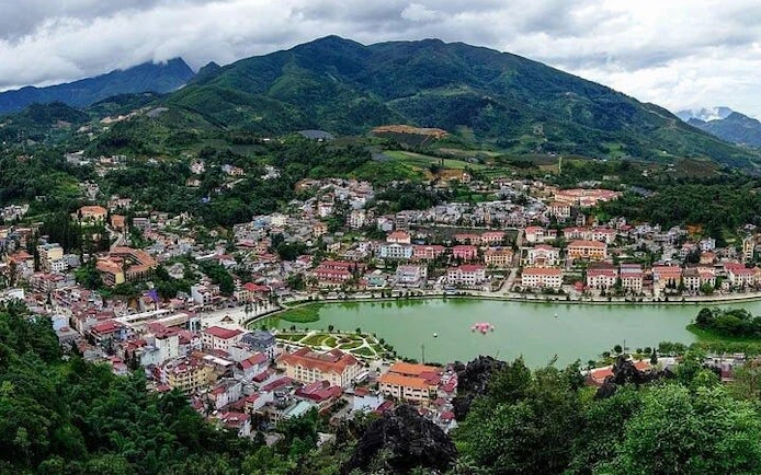 Sapa town with surrounding mountains and lake, view from trail on 21km guided running tour.