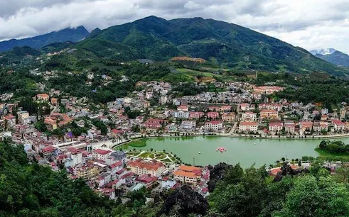 Sapa town with surrounding mountains and lake, view from trail on 21km guided running tour.