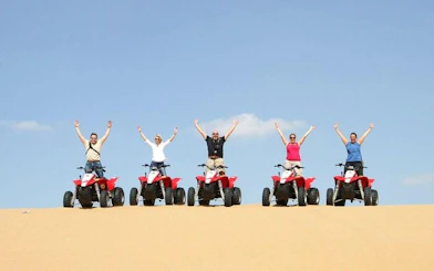 Group on quad bikes in Hurghada desert during safari tour.