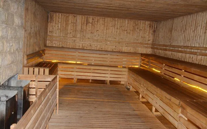 Traditional Moroccan hammam interior with wooden benches in Marrakech.