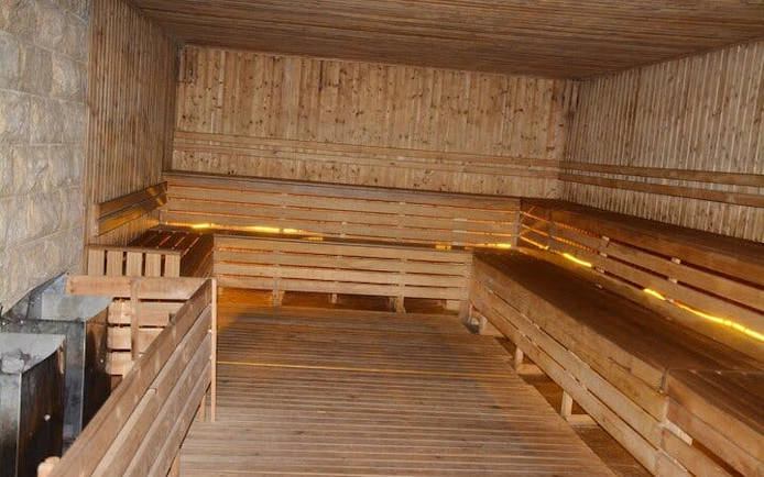 Traditional Moroccan hammam interior with wooden benches in Marrakech.