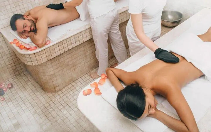 Couple receiving massages in a Turkish bath with rose petals, Sharm El Sheikh.