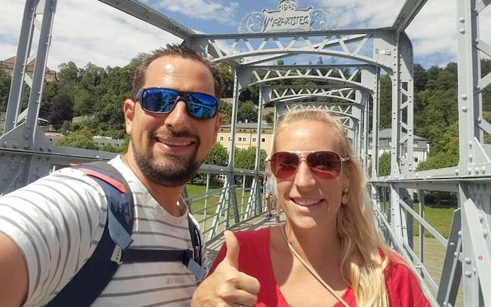 Couple on Mozart Bridge in Salzburg during self-guided city exploration game.