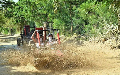Guided jungle buggy tour splashing through mud in Punta Cana.