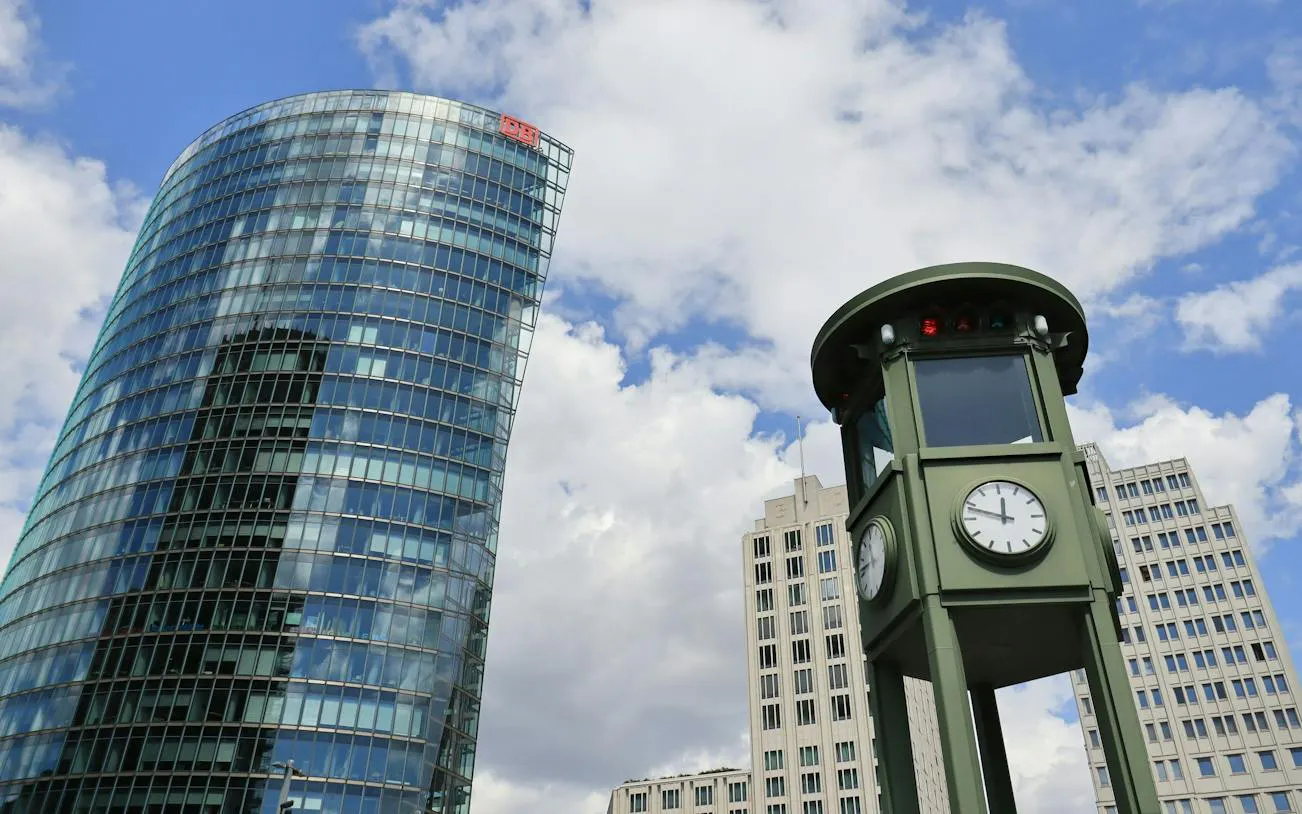 Berlin's Potsdamer Platz with modern buildings and historic traffic light tower.