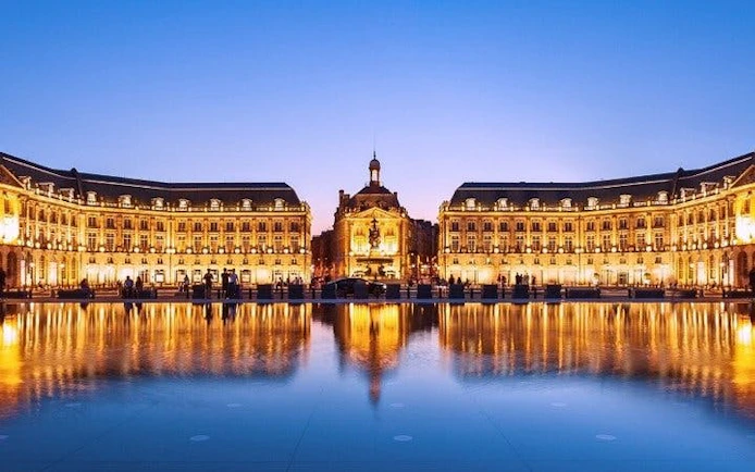 Place de la Bourse in Bordeaux at dusk, reflecting in the water mirror.