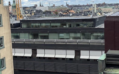 Rooftop view of Stockholm cityscape with modern buildings and historic architecture.