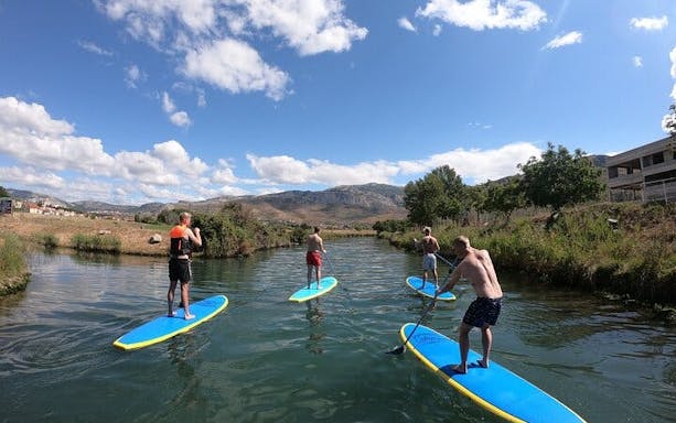 split stand-up paddleboarding tour across sea, river, and mountain landscapes-5