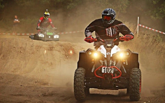 Quad bikes navigating a dirt track during Krakow off-road tour.