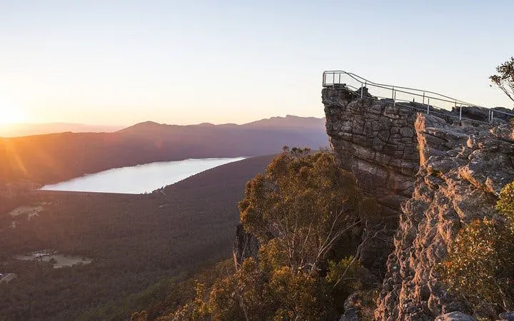 Grampians National Park lookout at sunset with distant lake and forest view.