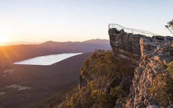 Grampians National Park lookout at sunset with distant lake and forest view.