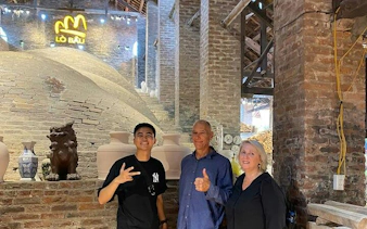 Visitors at Bat Trang Ceramic Village kiln during Hanoi Vespa tour.