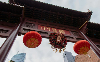 Chinatown archway with red lanterns and wreath, Melbourne Laneways and Arcades tour.