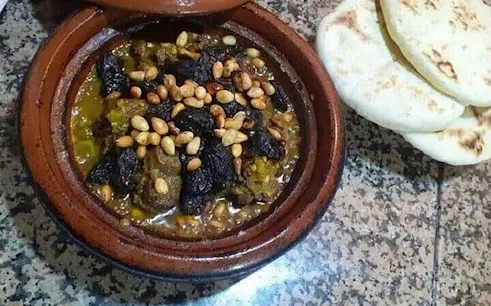 Moroccan tagine with prunes and nuts served with bread, Marrakesh cooking class.