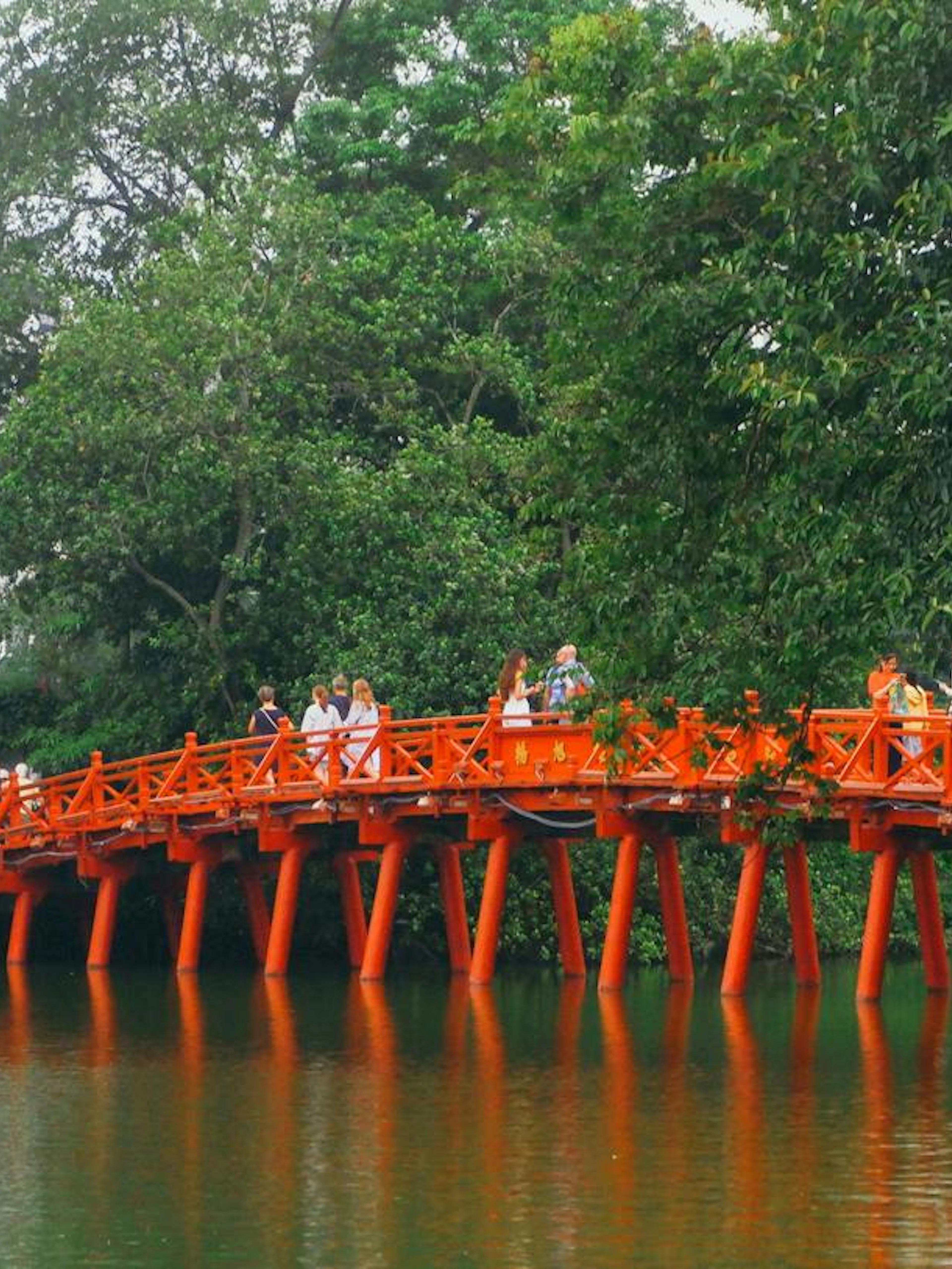Huc Bridge over Hoan Kiem Lake in Hanoi Old Quarter, part of self-guided audio walking tour.