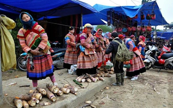 Vendors in traditional attire selling produce at Bac Ha Market, Sapa day trip by motorbike.