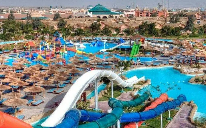 Water slides and pools at Makadi Water World, Hurghada, with sunshades and seating areas.