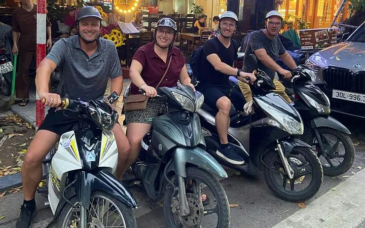 Group on motorbikes ready for Hanoi city tour with street food tastings.