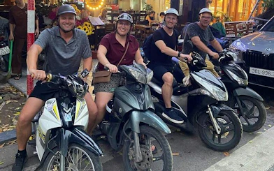 Group on motorbikes ready for Hanoi city tour with street food tastings.