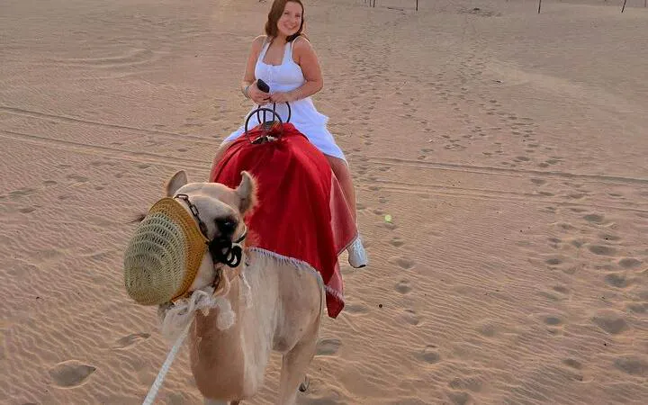 Camel ride in Abu Dhabi desert during safari tour.