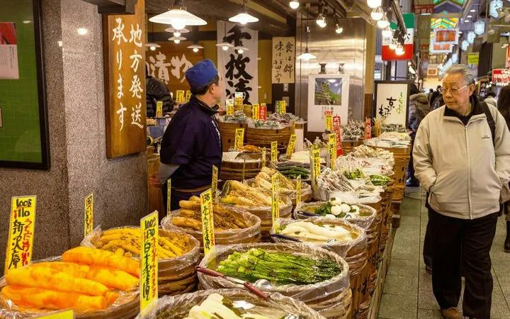 Stalls with pickled vegetables at Kyoto Nishiki Market during guided walking tour.