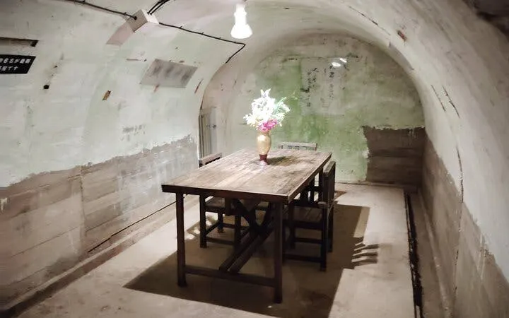 Underground room with wooden table and chairs in Okinawa WWII Navy HQ, Naha.