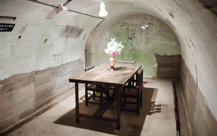 Underground room with wooden table and chairs in Okinawa WWII Navy HQ, Naha.