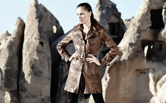 Cappadocia rock formations with person in leather coat during local shopping tour.