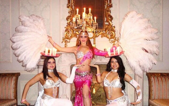 Cabaret dancers performing with feather fans and candles at Hot Nights Live in Hurghada.
