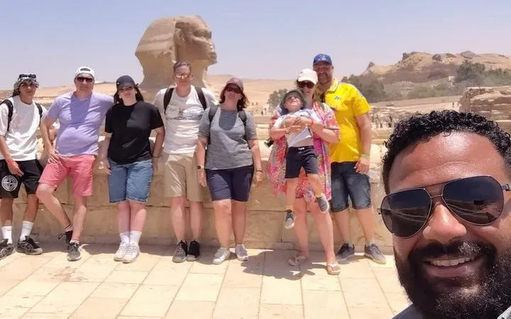 Group of tourists with guide at the Sphinx, part of Saqqara, Memphis, and Dahshur tour in Egypt.